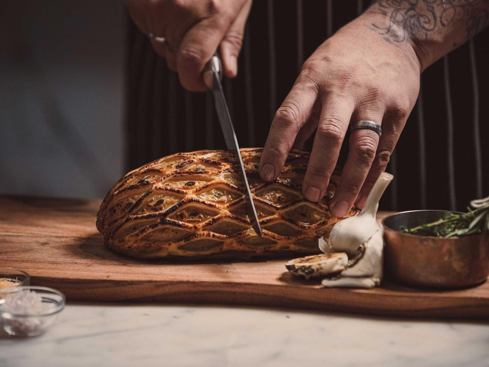 Horizon By Skycity Auckland Bagian luar foto Chef preparing a whole roasted suckling pig